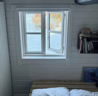 a window in a room with a bed in front of it at Traditional Summer House Near Blokhus Beach in Blokhus