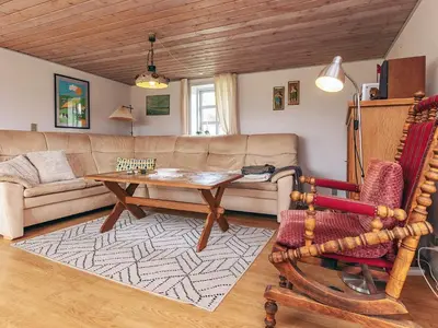 a living room with a couch and a table at 6 person holiday home in Vestervig in Vestervig