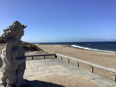 a statue of a woman standing next to the beach at 4 person holiday home in Vestervig in Vestervig