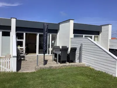 a house with chairs and a table in front of it at 4 person holiday home in Vestervig in Vestervig