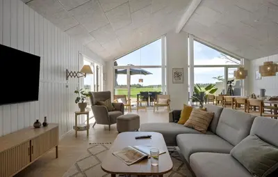 a living room with a couch and a tv at Pet Friendly Home In Saltum With Sauna in Saltum