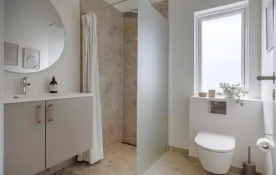 a white bathroom with a toilet and a window at Pet Friendly Home In Saltum With Sauna in Saltum