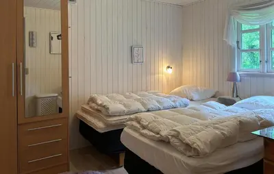 two large beds in a bedroom with a window at 2 Bedroom Cozy Home In Farsø in Farsø