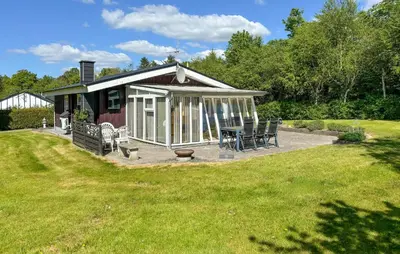 a gazebo with a table and chairs in a yard at 2 Bedroom Cozy Home In Farsø in Farsø