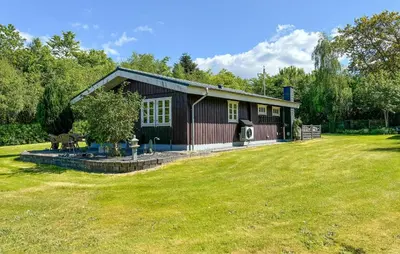 a small house with a yard in front of it at 2 Bedroom Cozy Home In Farsø in Farsø