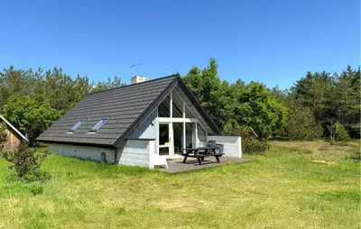 a small white shed with a bench in a field at 3 Bedroom Cozy Home In Fur in Furland