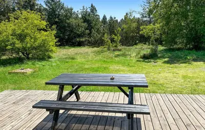 a wooden picnic table sitting on a wooden deck at 3 Bedroom Cozy Home In Fur in Furland