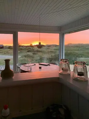 a room with a table with a view of the desert at Cosy, Traditional Summer House Close To The North Sea in Fjerritslev