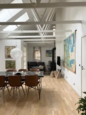 a living room with a dining room table and chairs at Stalden ved Hjarbækgård in Løgstrup