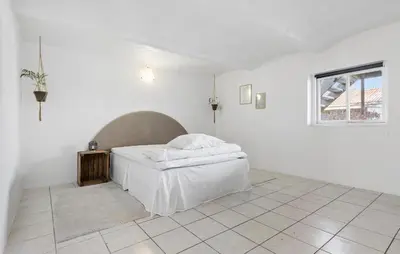 a white bedroom with a bed and a window at Lovely Home In Nibe With Lake View in Nibe