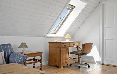 an attic room with a desk and a window at Gorgeous Home In Vestervig With Wifi in Vestervig