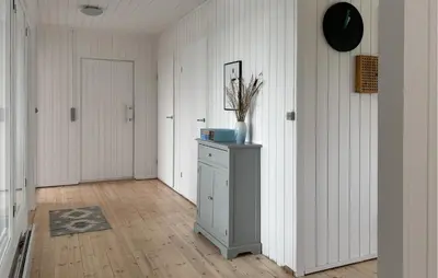 a room with a hallway with a cabinet and a door at 3 Bedroom Stunning Home In Øster Assels in Øster Assels