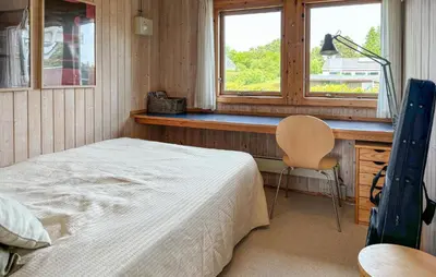 a bedroom with a bed and a desk and a window at 3 Bedroom Stunning Home In Øster Assels in Øster Assels