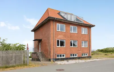 a red brick building with a gambrel roof at 3 Bedroom Amazing Home In Harboøre in Harboør