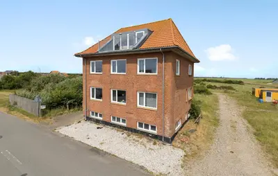 a brick building with a window on the side of a road at 3 Bedroom Amazing Home In Harboøre in Harboør