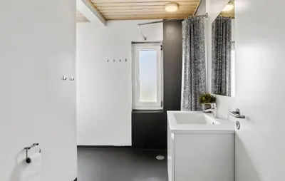 a white bathroom with a sink and a window at 3 Bedroom Amazing Home In Harboøre in Harboør