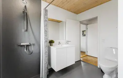a bathroom with a white sink and a shower at 3 Bedroom Amazing Home In Harboøre in Harboør