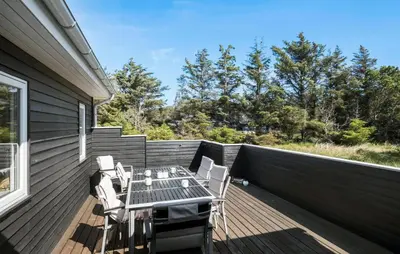 a patio with a table and chairs on a deck at Amazing Home In Løkken With Wifi in Løkken