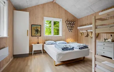 a bedroom with a bed and bunk beds at 3 Bedroom Amazing Home In Fur in Fur