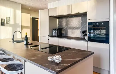 a kitchen with a counter with two wine glasses on it at Awesome Home In Vinderup With Sauna in Vinderup