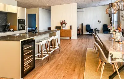 a kitchen and dining room with a table and chairs at Awesome Home In Vinderup With Sauna in Vinderup
