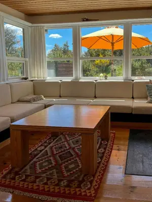 a living room with a couch and a coffee table at Architect-Designed Holiday Home By Saltum Beach in Saltum