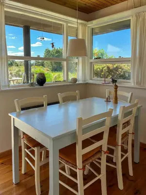a white table and chairs in a room with windows at Architect-Designed Holiday Home By Saltum Beach in Saltum