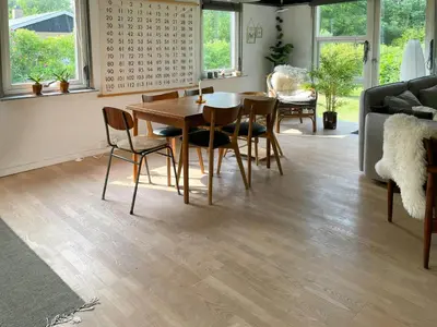 a living room with a wooden table and chairs at Family House By Frederik Vii Canal In Løgstør in Løgstør