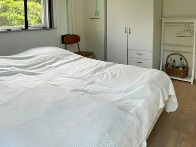 a large white bed in a bedroom with a window at Family House By Frederik Vii Canal In Løgstør in Løgstør