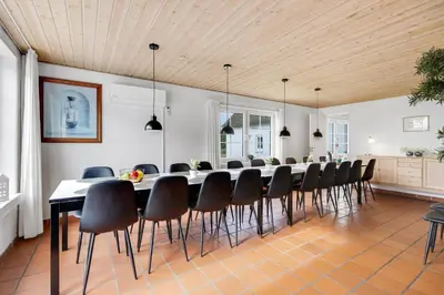 a large dining room with a long table and chairs at Large Pool House For 24 People, With Almost Everything In Activities, 300 Meters From The Fjord in Vinderup