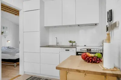 a kitchen with a bowl of fruit on a wooden table at Well-Maintained Holiday Home With Outdoor Shower And 5-Person Outdoor Hot Tub, Close To The North Sea In Klitmøller in Klitmøller