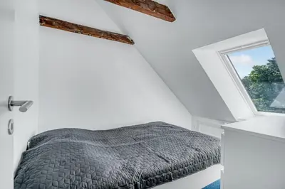 a bedroom with a bed and a window at Renovated Holiday Home With Free Consumption, Close To The North Sea And The Center Of Hanstholm in Hanstholm