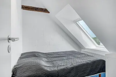 a bed in a white room with a window at Renovated Holiday Home With Free Consumption, Close To The North Sea And The Center Of Hanstholm in Hanstholm