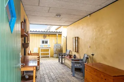 a living room with two chairs and a table at Charming Townhouse From 1877, Located In The Middle Of Løgstør Only 100 Meters From The Harbor in Løgstør