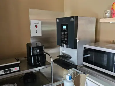 a kitchen with a microwave and a coffee maker at Compact standard single room in Lemvig in Lemvig