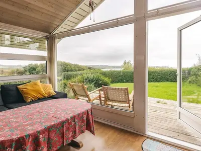 a screened in porch with a table and chairs at 4 person holiday home in Struer in Struer