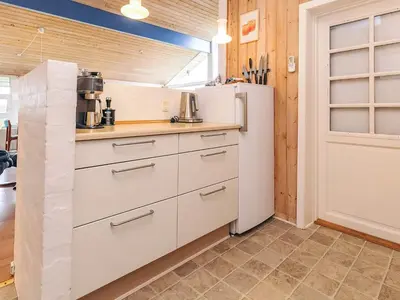 a kitchen with white cabinets and a refrigerator at 4 person holiday home in Struer in Struer
