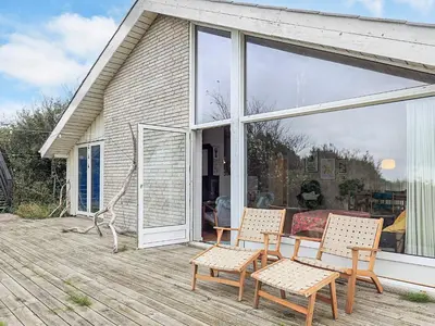 a patio with a table and chairs on a deck at 4 person holiday home in Struer in Struer