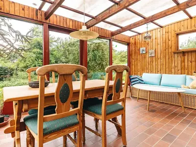 a dining room with a wooden table and chairs at 10 person holiday home in Spøttrup in Spottrup