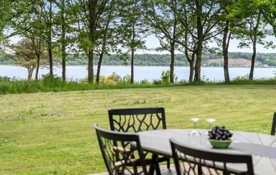 a table and chairs with a view of the water at Amazing Home In Roslev With Wifi in Roslev