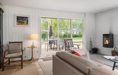 a living room with a couch and a table at Amazing Home In Roslev With Wifi in Roslev