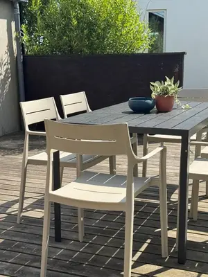 a wooden table with chairs and a bowl on it at Viking Surf Home in Klitmøller