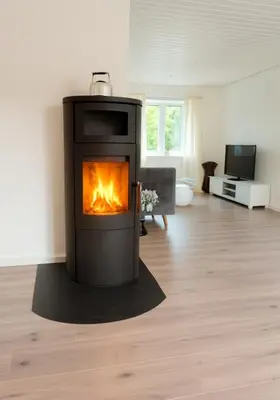 a fireplace in the middle of a living room at Guldmark in Lemvig