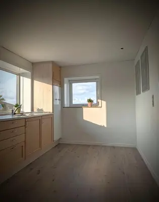 an empty kitchen with a sink and a window at Guldmark in Lemvig
