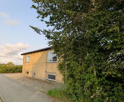 a brick building on the side of a road at Guldmark in Lemvig