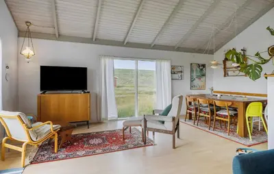 a living room with a television and a table and chairs at Awesome Home In Harboøre in Harboør