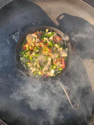 a pan of food is cooking on a grill at Koppes Mølle B&B - naturnær overnatning in Borup