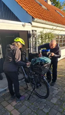 a man and a woman standing next to a bike at Koppes Mølle B&B - naturnær overnatning in Borup