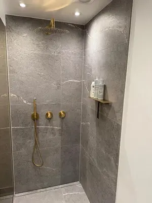 a bathroom with a shower with a glass door at Cozy harbor house in Nibe in Nibe