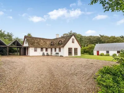 a large white house with a gravel driveway at Holiday Home Åsta - 400m to the fjord by Interhome in Roslev